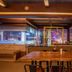 Hotel Grand Palace Chennai rooftop bar with wooden tables, stools and city lights at night