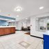 Lakewood Inn & Suites in Dowagiac lobby with front desk, tile floor, and seating area