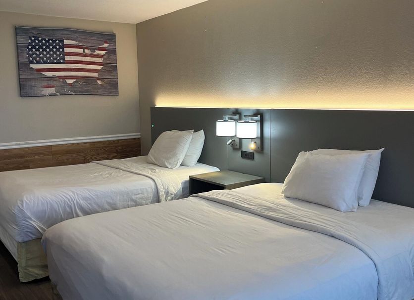 Hallmarc Inn & Suites of West Memphis guest room with two beds and wall art in West Memphis