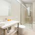 Splanzia Boutique Hotel in Chania bathroom with vanity sink, toilet, and glass shower enclosure