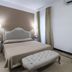 Hotel Gargallo in Siracusa guest room with double bed, tufted bench, nightstands and desk