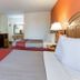 Motel 6 Clarksville Tn guest room with two beds, TV, dresser and vanity in Clarksville
