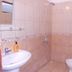 Fire pansiyon in Cirali bathroom with tiled shower, sink, mirror, and toilet