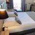 Hôtel Des Princes guest room in Évian-les-Bains with twin beds, desk, and balcony door