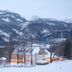 Hotel Jufa Grundlsee in Gössl with snow-covered lodge and mountain backdrop
