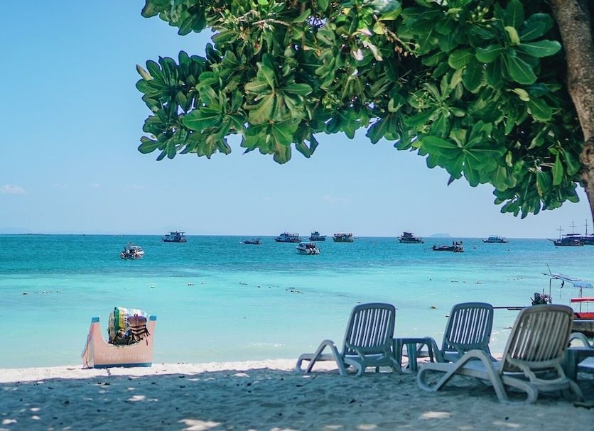Pp Nice Beach Resort in Ko Phi Phi with shaded beach chairs and clear turquoise sea