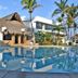 Mar Paraiso Queen in Acapulco with thatched-roof poolside bar and palm-lined swimming pool
