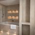 Tre-Ysgawen Hall & Spa bathroom in Llangefni with bathtub, shower, and illuminated recessed shelves
