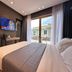 Mulaj Hotel in Tirana room with balcony view, wall-mounted TV and bed