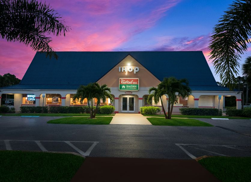 Red Roof Inn Vero Beach - I-95 exterior at dusk with illuminated entrance and palm trees