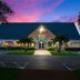 Red Roof Inn Vero Beach - I-95 exterior at dusk with illuminated entrance and palm trees