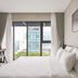 Triple E Hotel Metro Ben Thanh room with a bed, desk, and city-view window in Ho Chi Minh City