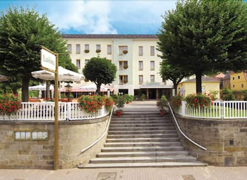 Elbhotel Bad Schandau in Bad Schandau, exterior with central steps, terrace, and trees