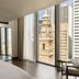 Capella Sydney room with floor-to-ceiling windows overlooking Sydney Clock Tower and city skyline