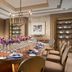 Mulia Resort, South Kuta: elegant private dining room with long banquet table, floral centerpiece and chandelier