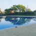 Monte das Palmeiras in Ferreira do Alentejo, outdoor pool reflecting trees and blue sky