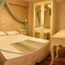 Panamare Apart Hotel Akyaka bedroom in Akyaka with double bed, draped canopy and mirrored wardrobe