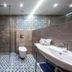 Hotel Paryski Art & Business in Zakopane bathroom with walk-in shower, patterned tile floor and wall-mounted sink