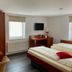 Weserlounge Hotel Garni in Hessisch Oldendorf guest room with twin beds, desk, TV, and wardrobe