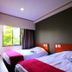 Hotel Matsukaze in Toyota guest room with two beds and open window