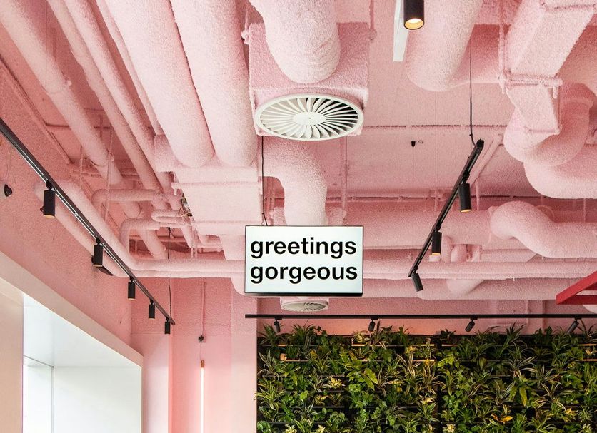 Conscious Hotel Vondelpark in Amsterdam cafe with pink ceiling, yellow chairs and a green wall