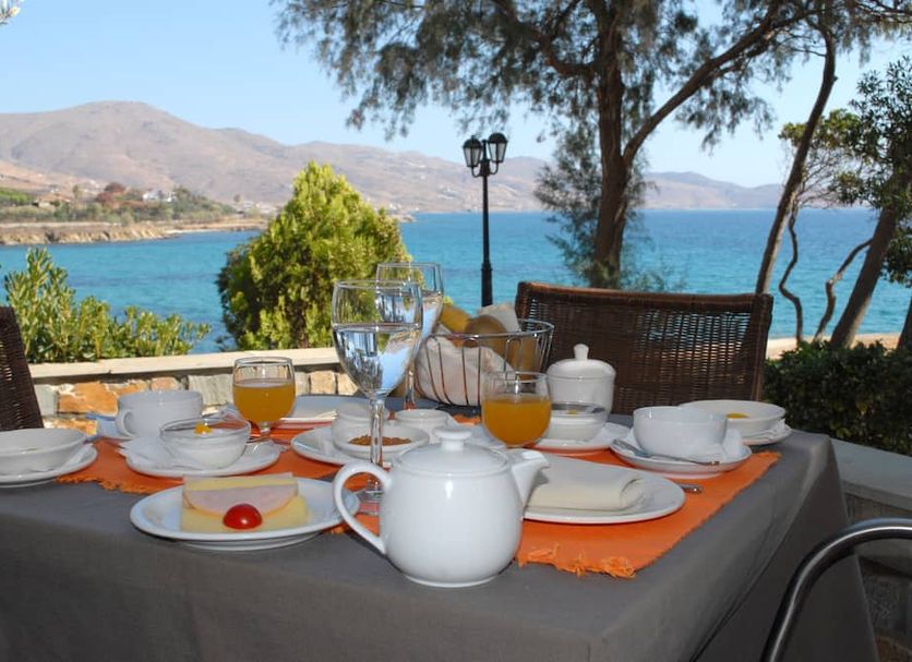 Outdoor breakfast table at Karystion Hotel in Kárystos with sea and mountain views