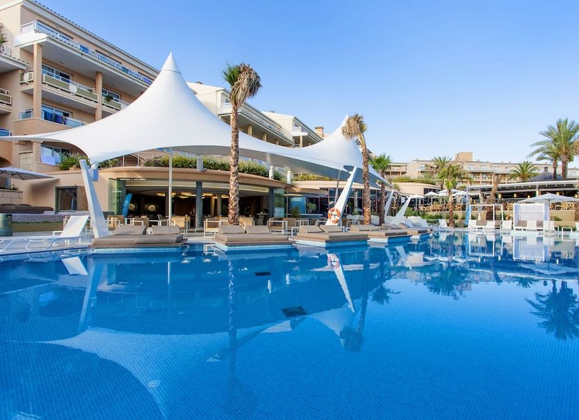 Insotel Cala Mandia Resort in Porto Cristo with a large outdoor pool and palm-lined terrace