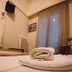 Hotel King Pyrros, Ioánnina: cozy guest room with twin beds, rolled towels, and curtained window