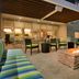 Home2 Suites by Hilton Anchorage/Midtown courtyard fire pit with seating and colorful lounge chairs