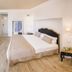 Domus Maris Relais Boutique Hotel in Sciacca: bright guest room with king bed, desk, TV and bathroom doorway