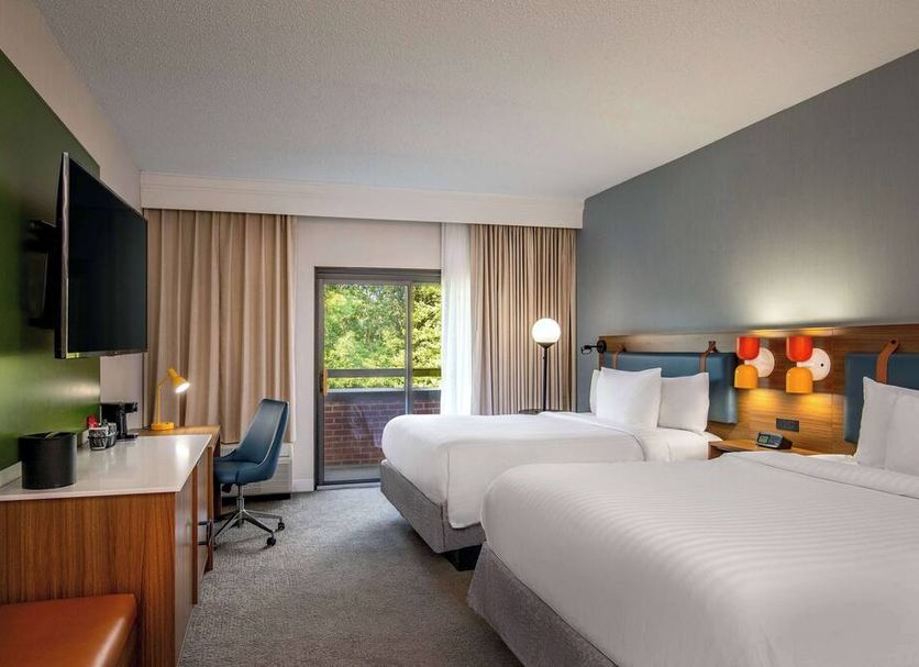 Sonesta Select Boston Foxborough Mansfield guest room with two beds, desk, and balcony view