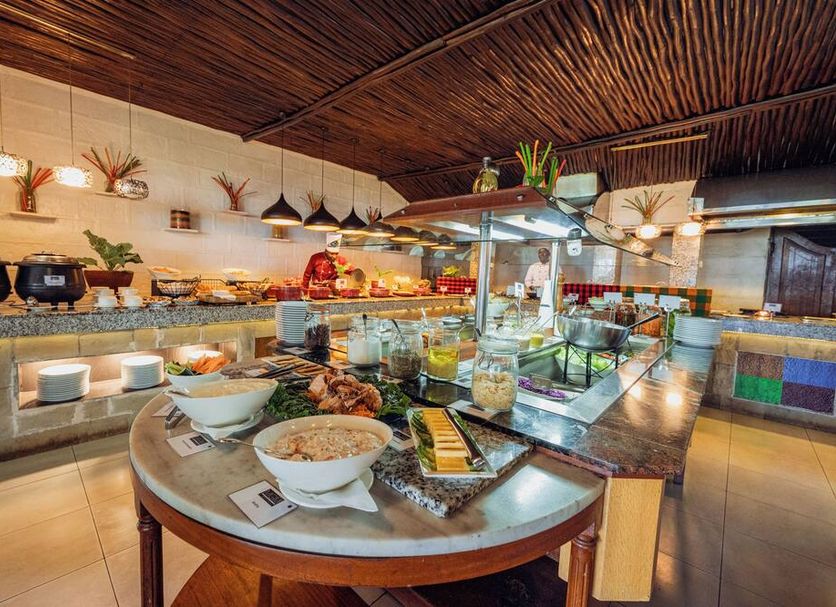 Muthu Lake Naivasha Country Club buffet station with salads, dishes and glass display counter in Naivasha