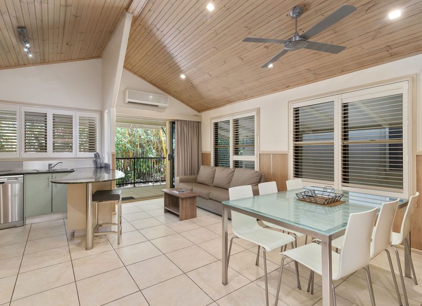 Ashmore Palms Holiday Village in Ashmore: open-plan villa with kitchen, dining area, lounge, and balcony