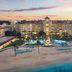 British Colonial Nassau beachfront resort with illuminated pool deck at sunset in Nassau
