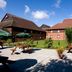 Premier Inn Christchurch - East in Christchurch courtyard with picnic tables, potted plants and brick buildings