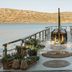 Domes of Elounda, Autograph Collection private pier over calm sea with hills in the distance