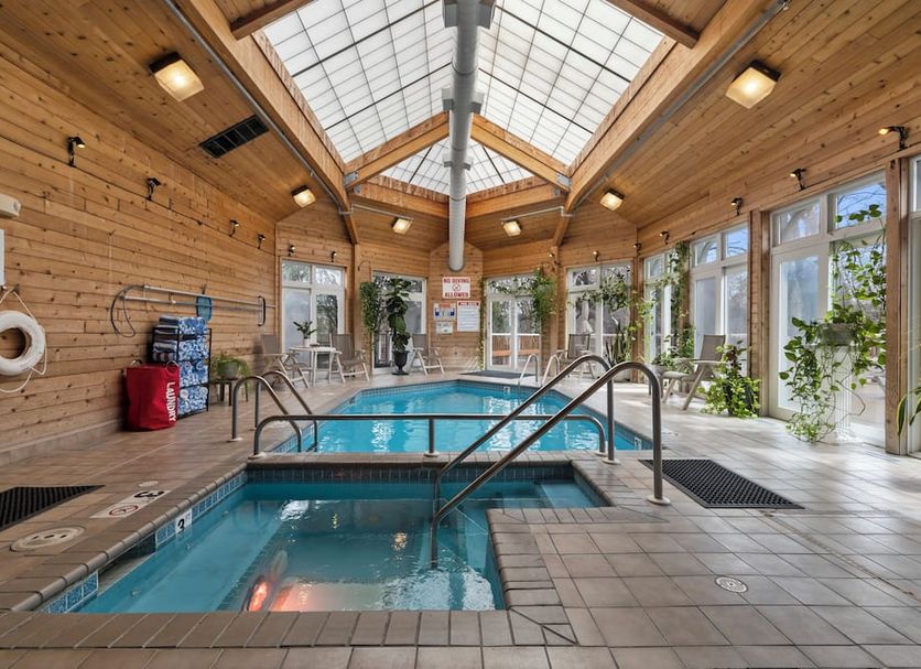 Mill Creek Hotel in Lake Geneva indoor pool and hot tub with skylight and wood-paneled walls
