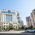 Yichang Guobin Bandao Hotel in Yichang, exterior view with palm trees and city buildings