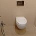 Hotel Rajmata Pvt Ltd Hyderabad bathroom with wall-mounted toilet and handheld bidet spray