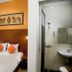 Hotel Poncowinatan - Tugu room with bed and attached bathroom, Yogyakarta