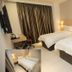 Extreme Boutique Hotel Kluang guest room with two twin beds, desk, wall TV, and curtains