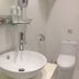 Royal Hotel Taipei City bathroom with vessel sink, wall-mounted mirror shelf, and toilet
