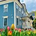 Ginkgo House on Harvard in Cambridge, blue hotel exterior with tulips and a porch