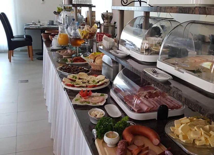 Hotel Ackermann in Riedstadt buffet table with pastries, fruit, cold cuts and covered serving trays