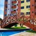 Golden Dolphin Supreme in Caldas Novas with wooden arched bridge over a pool and apartment tower