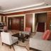 Anemon Ege Hotel in Izmir lobby seating area with sofas, armchairs, tables, and staircase