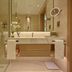 Onyx Rotana in Manama bathroom with glass shower, floating vanity, and illuminated mirror
