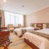 Jinan Jier Hotel in Jinan guest room with two beds, TV, and large window