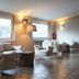 Borgo di Fiuzzi Resort & Spa lounge in Praia a Mare with wicker chairs and large windows