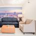Clarion Pointe Winston - Salem Downtown lounge with sofa, armchairs and cityscape wall mural in Winston-Salem